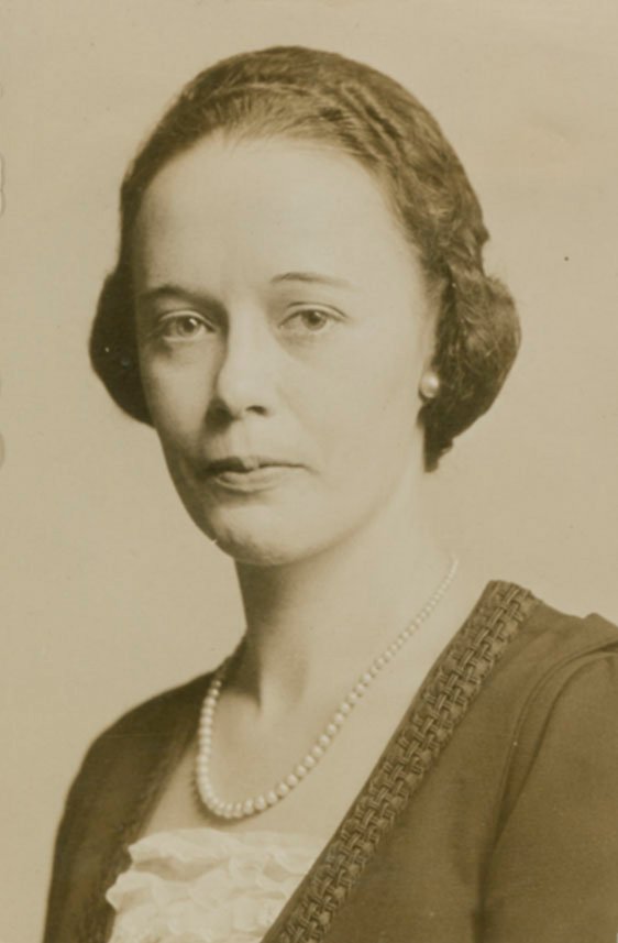Image Description. Sepia photograph of a Caucasian woman with a neutral expression.