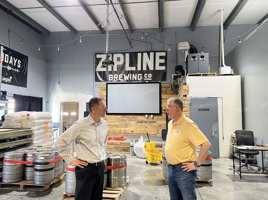 Nate Kauffman speaks with Mark Lawson during a tour of Zipline Brewing in Lincoln, NE.