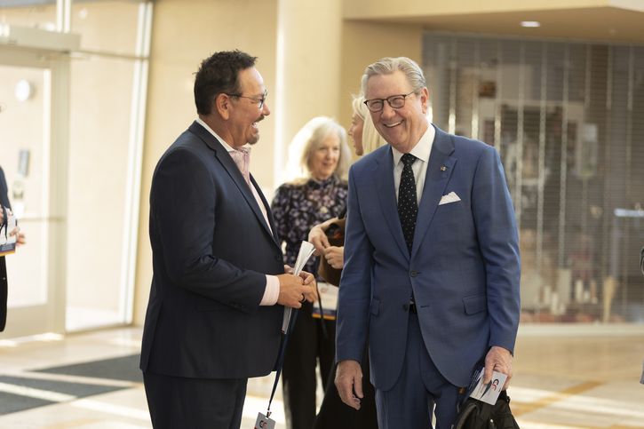Del Esparza, Denver Branch Board Chair and Chief Executive Officer of Esparza Digital + Advertising (left), talks with President Schmid before the Economic Forum of Albuquerque event.