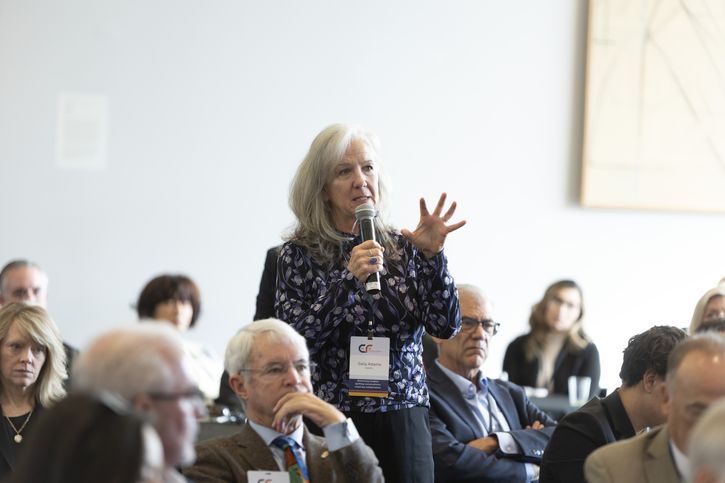An attendee of the Economic Forum of Albuquerque event asks a question during a Q&A segment.