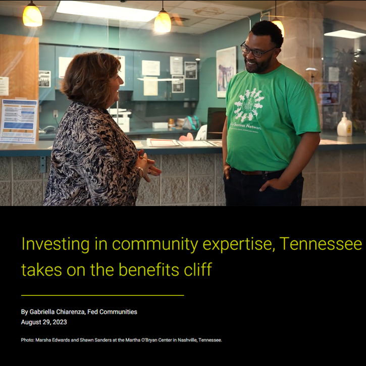 A middle-aged white woman talks with a younger black man. The image relates to a story about a pilot project in Tennessee to help families navigate benefits cliffs.