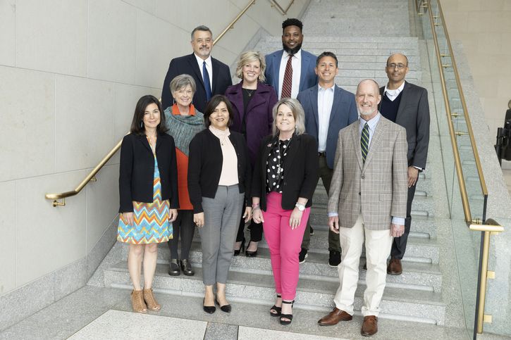 The photo include members of the CDAC who attended the April meeting. The group includes five women and five men of different races and ethnicities, standing on the grand staircase in the lobby of the Kansas City Fed building.