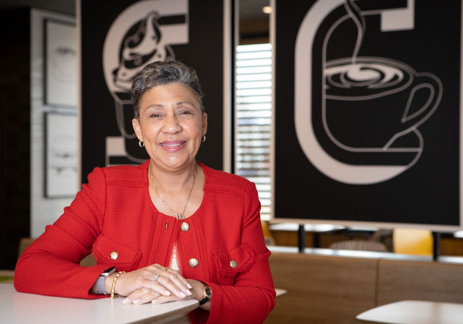 Cassandra Savage of the Kansas City Fed's Board of Directors sitting in a coffee shop.