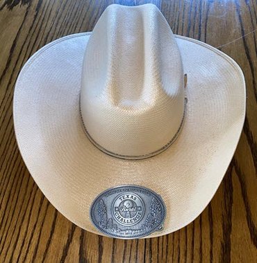 Cowboy hat and belt buckle that Dell was given as a thank-you.