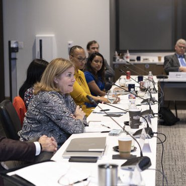 Esther George talks with CDAC members in April 2022
