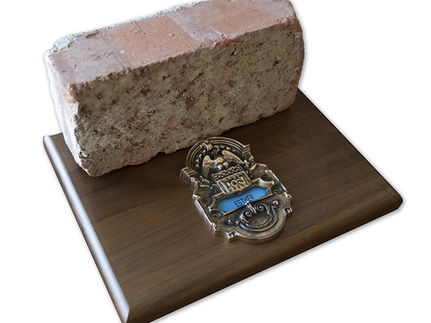 A red brick and a brass doorplate from the Kansas City Fed's former headquarters at 925 Grand in Kansas City.