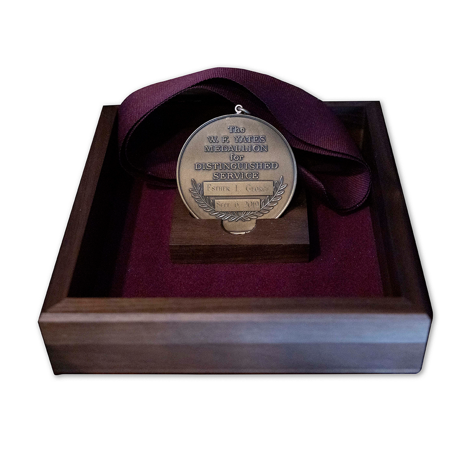 The W.F. Yates Medallion for Distinguished Service sitting in a wooden box lined with velvet.