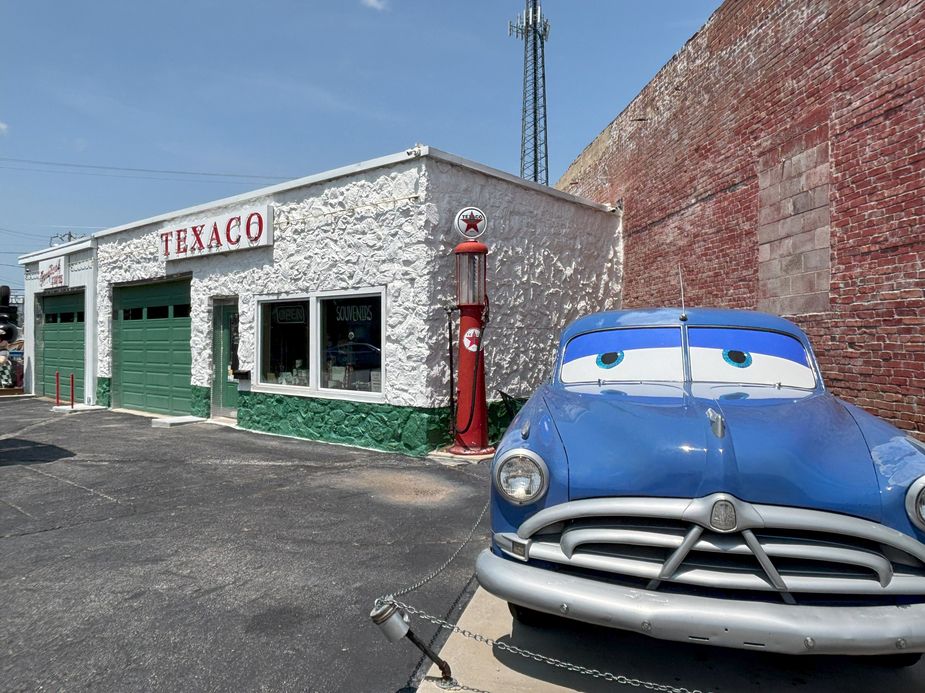 A car outside of a Texaco building.