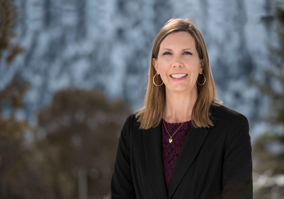 Rachel Gerlach of the Kansas City Fed's Denver Branch Board of Directors standing outside in a suit.