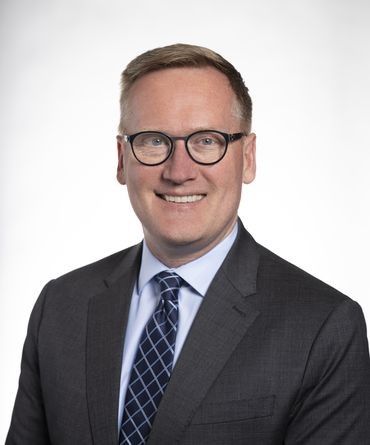 This is Jeremy Hegle, pronounced Higgly. He's a tall, blonde-haired man of about 50, wearing glasses, a suit and a blue shirt with a tie.