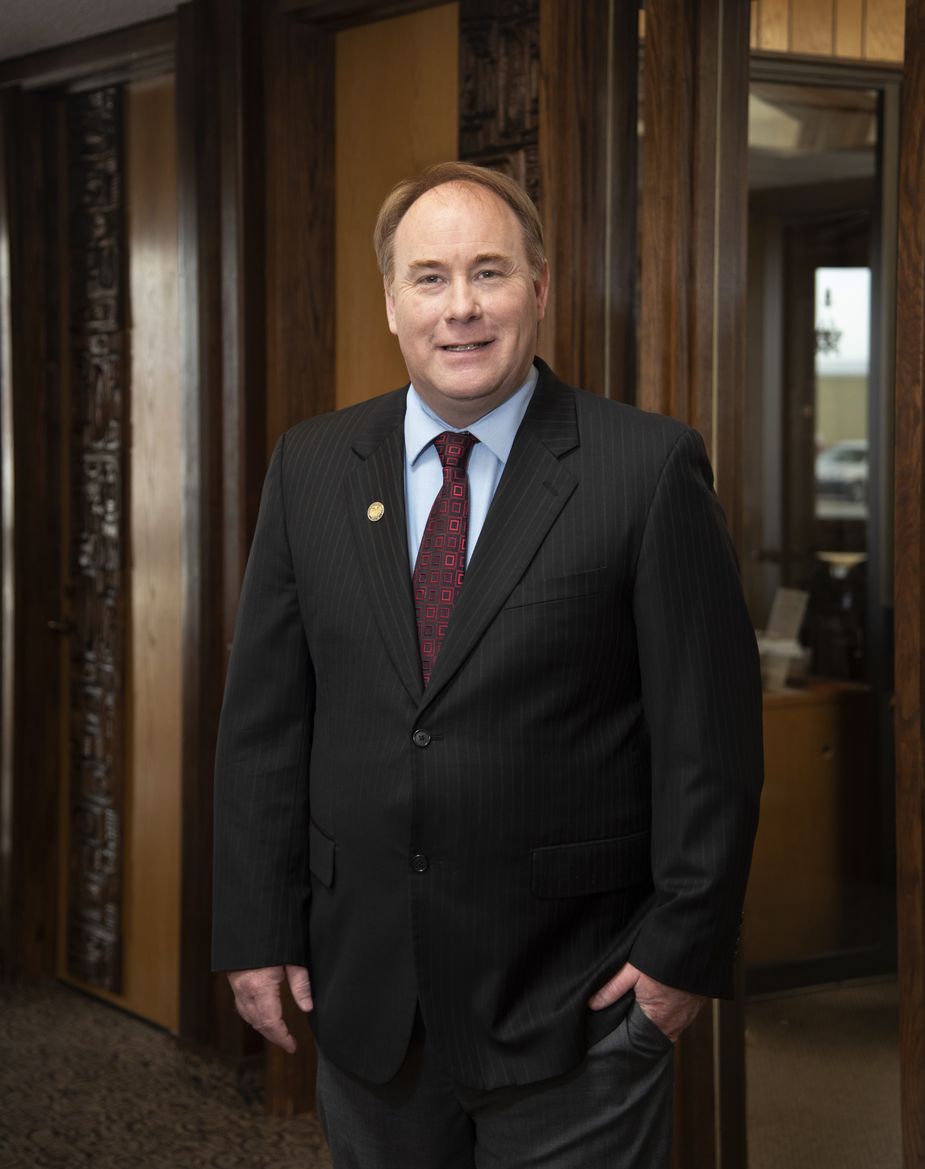 John Coyne of the Kansas City Fed's Denver Branch Board of Directors standing in front of an office doorway.