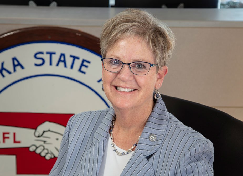 Sue Martin of the Kansas City Fed's Omaha Branch Board of Directors sitting in the Nebraska State AFL-CIO in a suit.