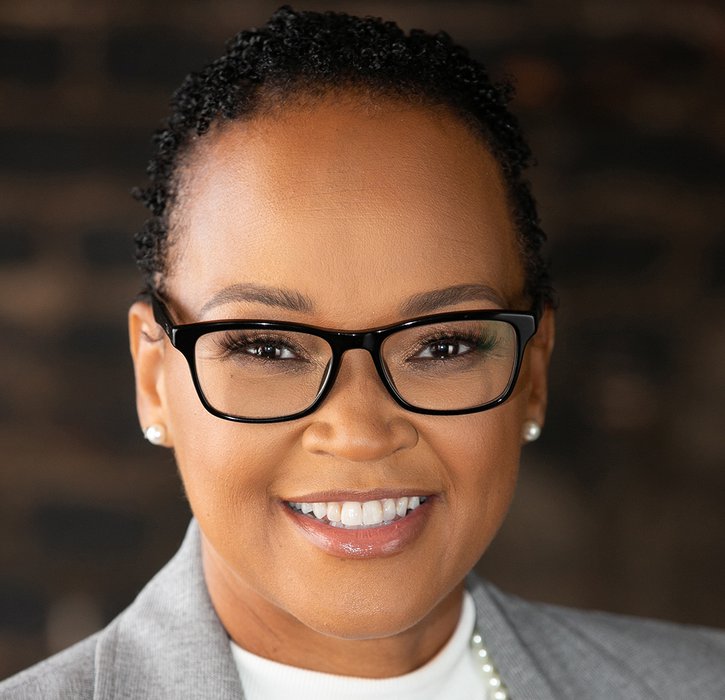 Teesha Miller of the Federal Reserve Bank of Kansas City smiling in a suit.