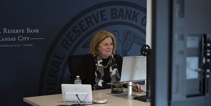 Kansas City Fed President Esther George sitting at a desk participating in a virtual event.