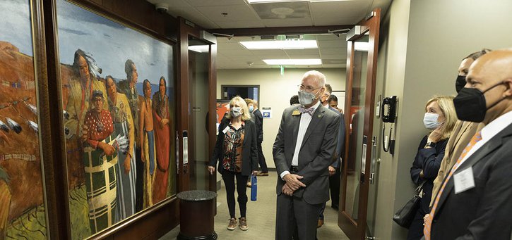 Kansas City Fed's board of directors looking at the painting titled Cloud People which hangs in the Bank's Oklahoma City Branch.