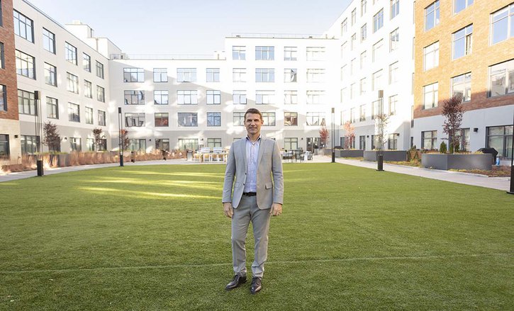 Developer Jonathan Arnold stands in front of Kansas City's Second and Delaware apartment building which has been certified as the world's largest passive solar house.